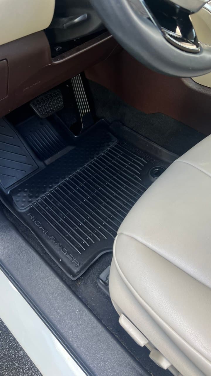 The same vehicle footwell with a spotless, freshly detailed floor mat after our service