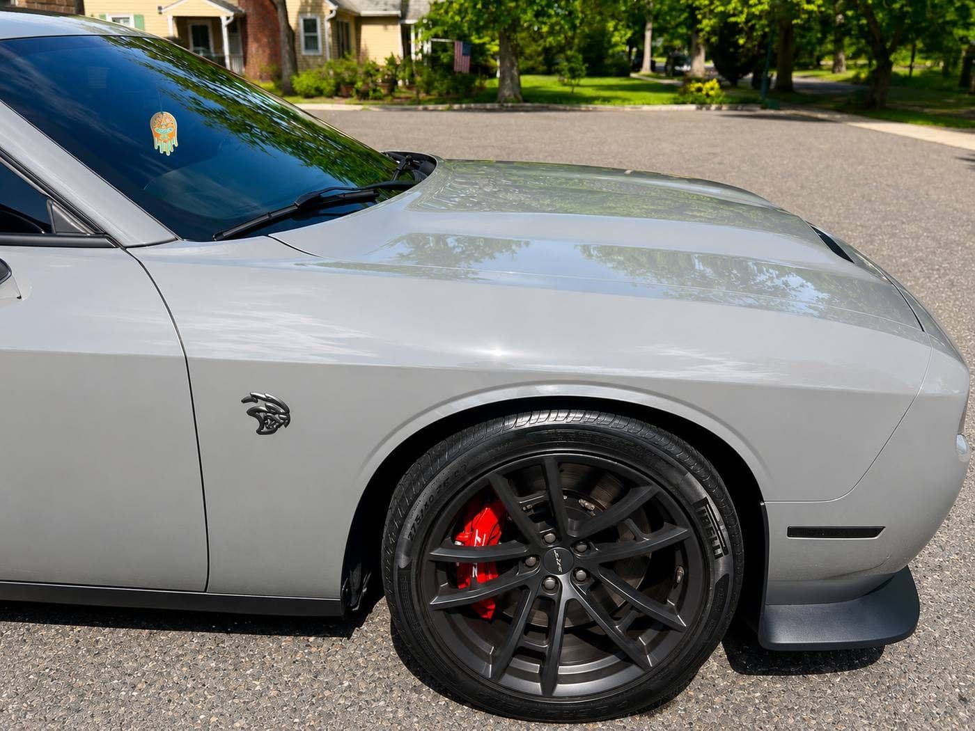 Gleaming silver Dodge Challenger Hellcat exterior with red brake calipers