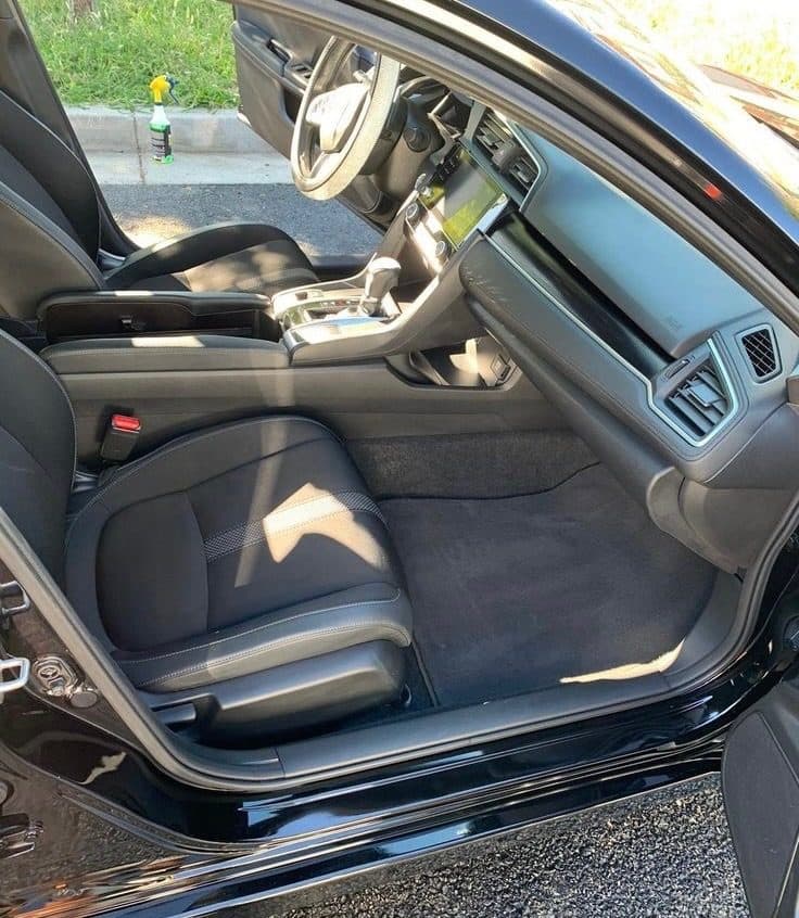 Clean Honda Civic interior after detailing — dark seats and fresh carpets